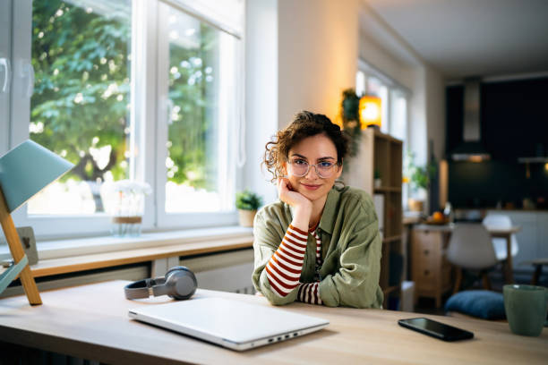 Portrait of young Caucasian woman at her home office.