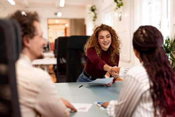 A friendly office environment with professionals engaging in a positive and productive meeting. Highlights teamwork, communication, and professional enthusiasm in a collaborative workplace setting.